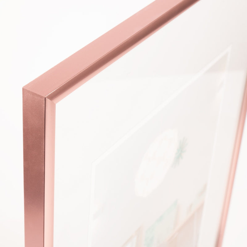 Close-up of a rose gold frame corner on a white background