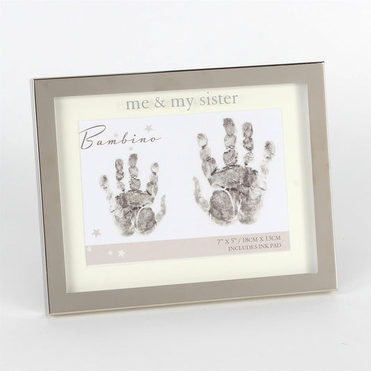 Framed handprint kit with 'me & my sister' text and handprints on a white background