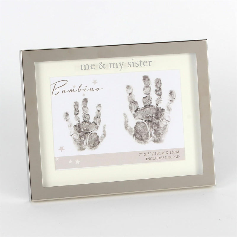 Framed handprint kit with 'me & my sister' text and handprints on a white background