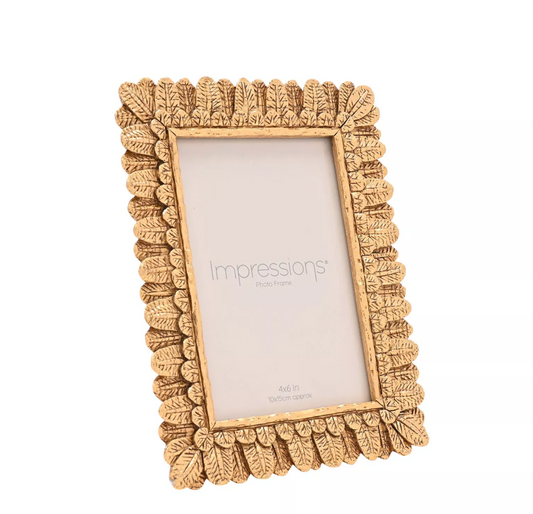 Decorative gold picture frame with 'impressions' branding on a white background