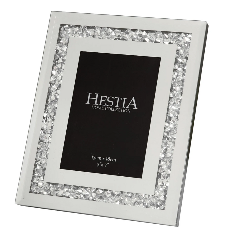 Silver photo frame with gemstone accents on a white background