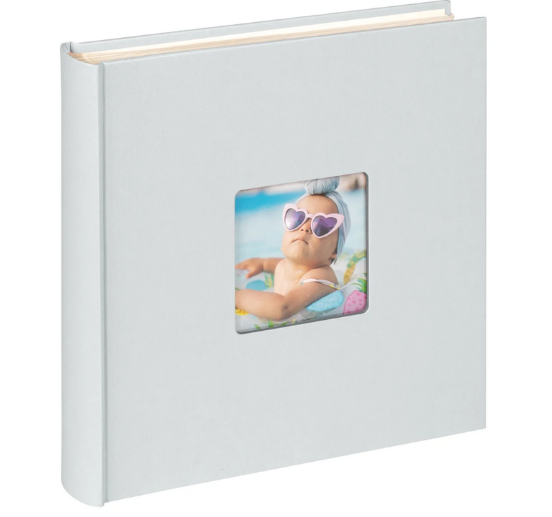 White photo album with a baby picture on a white background