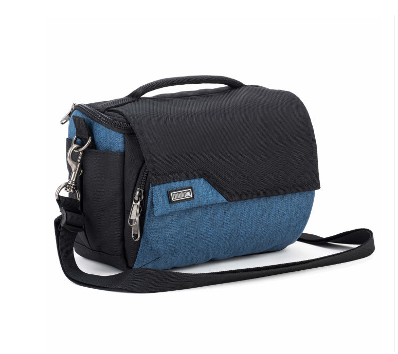 A black and blue camera bag with a top handle, front zip pocket, side pocket, and adjustable shoulder strap, shown on a plain white background.