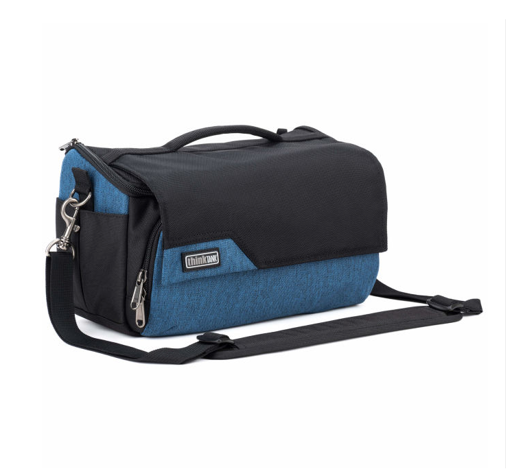 A blue and black camera bag with a top handle, zippered compartments, and a detachable shoulder strap, shown on a plain white background.