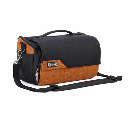 A black and orange camera bag with a top handle, front zippered pocket, and an adjustable shoulder strap, shown on a plain white background.