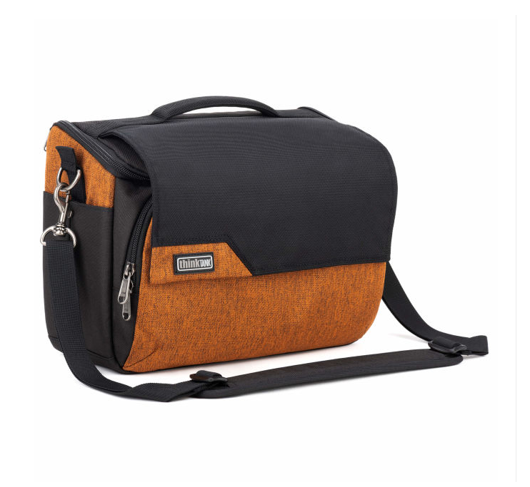A black and orange messenger bag with a top handle, front zippered pocket, and adjustable shoulder strap, shown on a plain white background.
