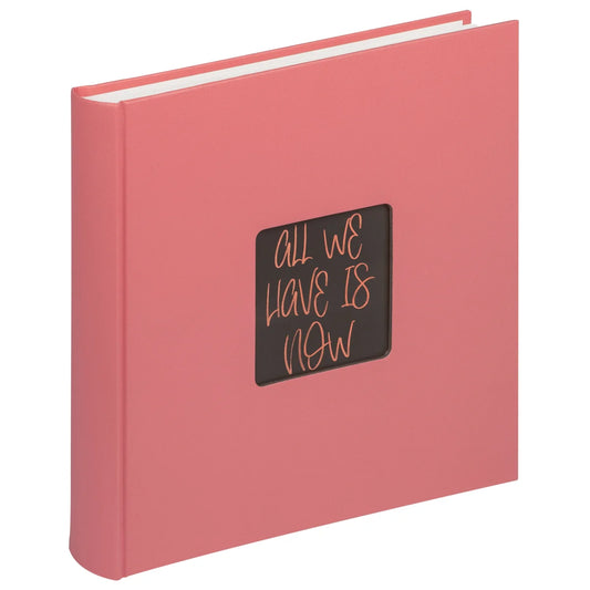 Pink book with a black square on the cover featuring text, on a white background