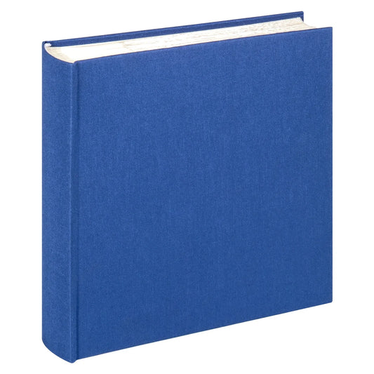 A hardcover photo album with a textured blue fabric cover, standing upright at a slight angle to show its spine and page edges against a plain white background.