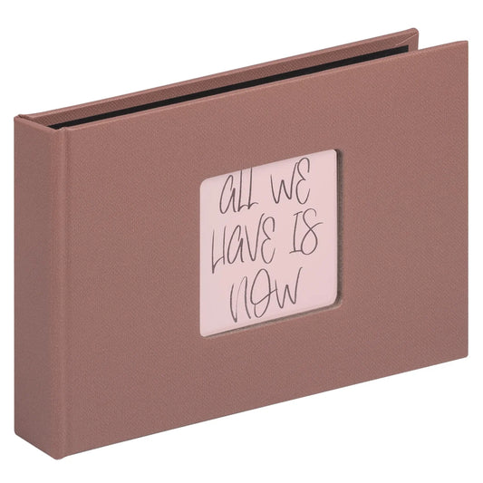 Brown photo album with a small window displaying 'All We Have Is Now' text on a white background